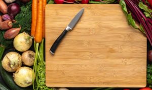 cutting board with knife and food