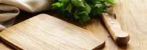 cutting board with knife and cilantro