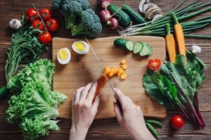 person cutting and preparing vegetables